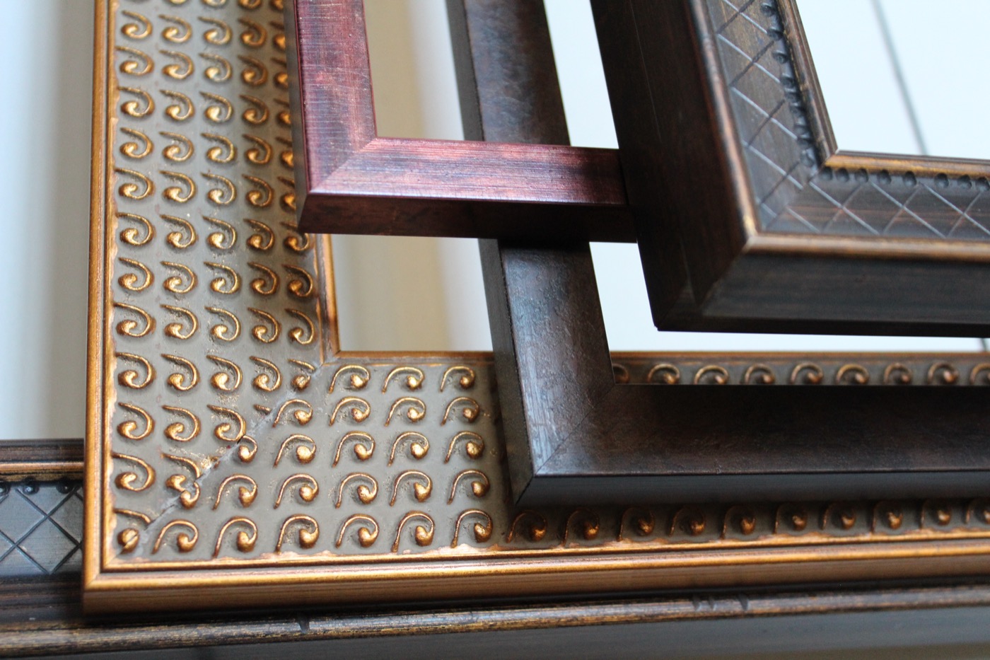 Framed landscape pieces displayed on an exposed brick wall